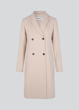 Beautiful, knee-length wool coat. Odelia coat, in season color Summer Sand, is closed at front by 4 buttons and is fitted around the waist, which gives a feminine look. Because of the high content of wool the jacket will be perfect for fall and the mild winters.