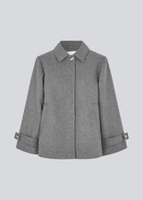 Classic short jacket in a wool mix. Ofiamd jacket has a relaxed fit, hidden button closure and collar. The model is 175 cm and wears a size s/36.