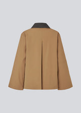 Lose jacket in beige with a contrast corduroy collar and hidden press buttons. Orkidemd jacket has an inverted pleat on the back. 