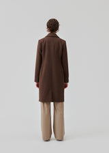 Beautiful, long wool coat in dark brown. Pamela coat is closed by 3 big buttons at front and is waisted, which gives a feminine look. Because of the high content of wool you will be able to keep warm all through fall and the mild winters. The model is 176 cm and wears a size S/36
