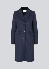 Beautiful, long wool coat in navy. Pamela coat is closed by 3 big buttons at front and is waisted, which gives a feminine look. Because of the high content of wool you will be able to keep warm all through fall and the mild winters.