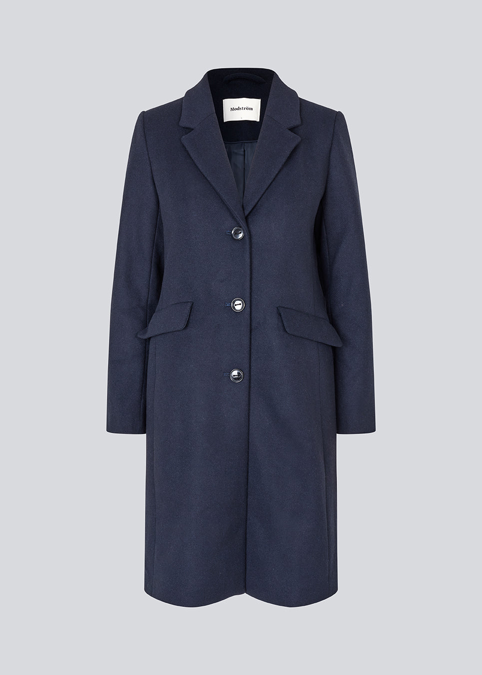 Beautiful, long wool coat in navy. Pamela coat is closed by 3 big buttons at front and is waisted, which gives a feminine look. Because of the high content of wool you will be able to keep warm all through fall and the mild winters.