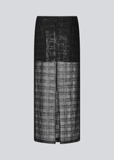 Long skirt in a transparent material with sequins. Pearleenmd long skirt has lining, an invisible side zipper, and a slit.