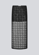Long skirt in a transparent material with sequins. Pearleenmd long skirt has lining, an invisible side zipper, and a slit.