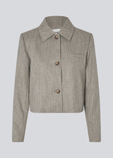 Short jacket with a shirt collar and front button closure. Popemd jacket has long sleeves with slits and a chest pocket. The model is 175 cm and wears a size S/36.