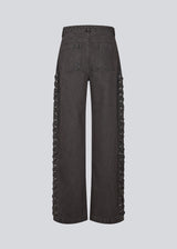 Light black/grey Jeans with wide legs. The Riyamd pants feature a high waist and decorative details along the legs – giving them a cool and edgy look.