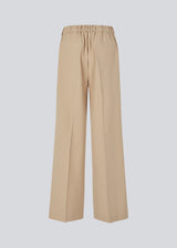 Wide-leg beige suit trousers with pink pinstripes. Sarahmd pants have press pleats, belt loops, zipper and elastic at the back waist for optimal comfort and style.