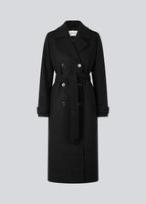 Classic, double-breasted wool coat in black with collar and notch lapels. ShayMD coat has a wide tiebelt at waist, shoulder straps, wide cuffs and open yoke. With lining and single back vent.