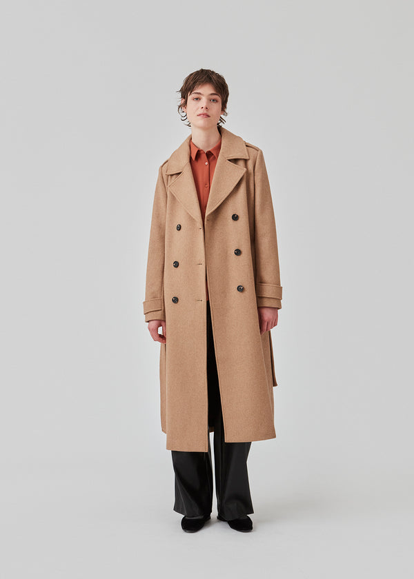 Classic, double-breasted wool coat with collar and notch lapels. ShayMD coat, in the color Brown Sugar, has a wide tiebelt at waist, shoulder straps, wide cuffs and open yoke. With lining and single back vent.