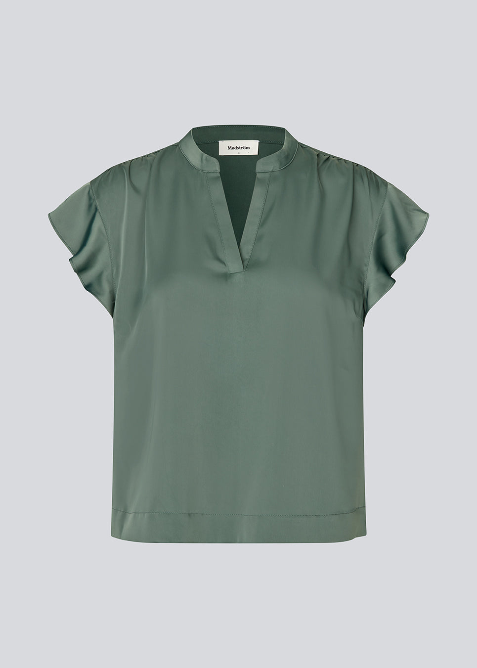 Sleeveless top with frilly details. TailorMD SS top has a loose fit and a V-neck. The model is 177 cm and wears a size S/36.