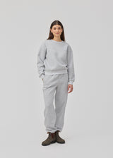 Sweatpants in grey with logo in a cotton mixture. TiaMD pants have sidepockets, tieband and an elastic in the bottom and waist.