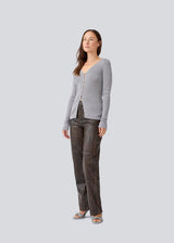 Fine knit cardigan with a v-neck. TomMD cardigan has long sleeves and a button closure in front.