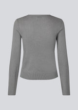 Fine knit jumper in a drapy quality. TomMD o-neck has a slightly cropped length with long, flared sleeves. Ribknit on neckline and hem.