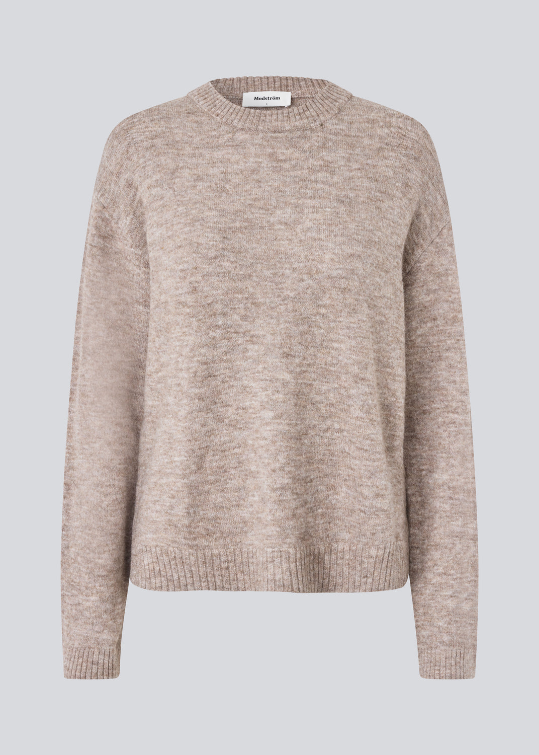 Loose knit in beige melange in plain jersey knit. TreeMD o-neck has a round neckline and long loose sleeves.