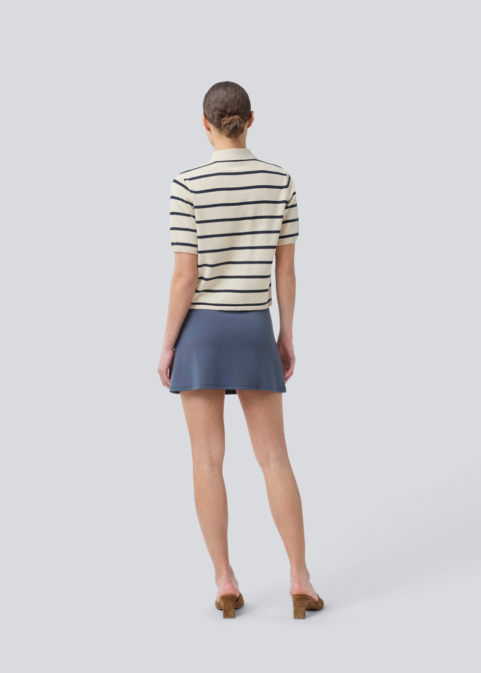 Short flared skirt in a stretchy material in dark blue. TurnerMD flare skirt has an elastic waistband. Match the skirt with the top: TurnerMD tank top.