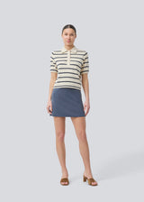 Short flared skirt in a stretchy material in dark blue. TurnerMD flare skirt has an elastic waistband. Match the skirt with the top: TurnerMD tank top.