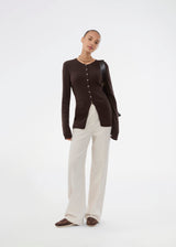 Timeless rib-knit cardigan in brown with a round neckline and front button closure. The UvisMD Cardigan features a fitted silhouette and a soft quality that gives it a feminine and elegant look. Perfect for everyday wear and layering through the seasons. The model is 175 cm and wears a size S/36.
Material:
100% Organic Cotton