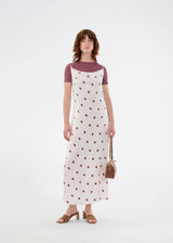 Long white satin dress with polka dots. The Vanjamd Print Dress features delicate spaghetti straps, a cowl neckline, and a loose, elegant drape that creates a feminine and modern look.