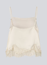 Delicate satin top in white/cream with lace details. Vuemd top has adjustable straps and refined lace details at the hem. Perfect worn alone or styled as part of a layered look.
