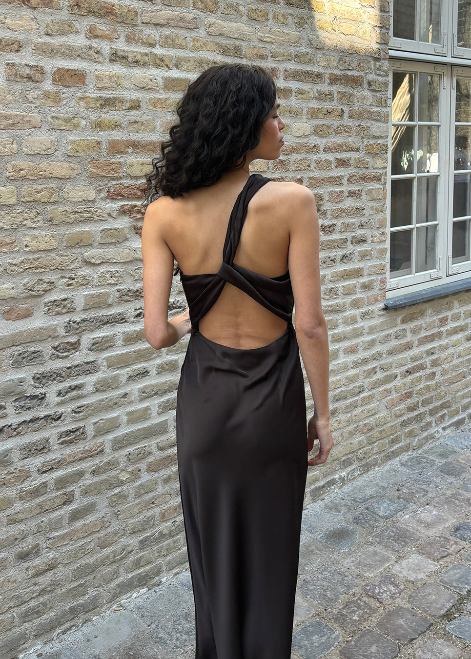 Dark brown maxi one-shoulder dress in satin. NarcissaMD dress has an open back with beautiful details and an invisible zipper on the side.