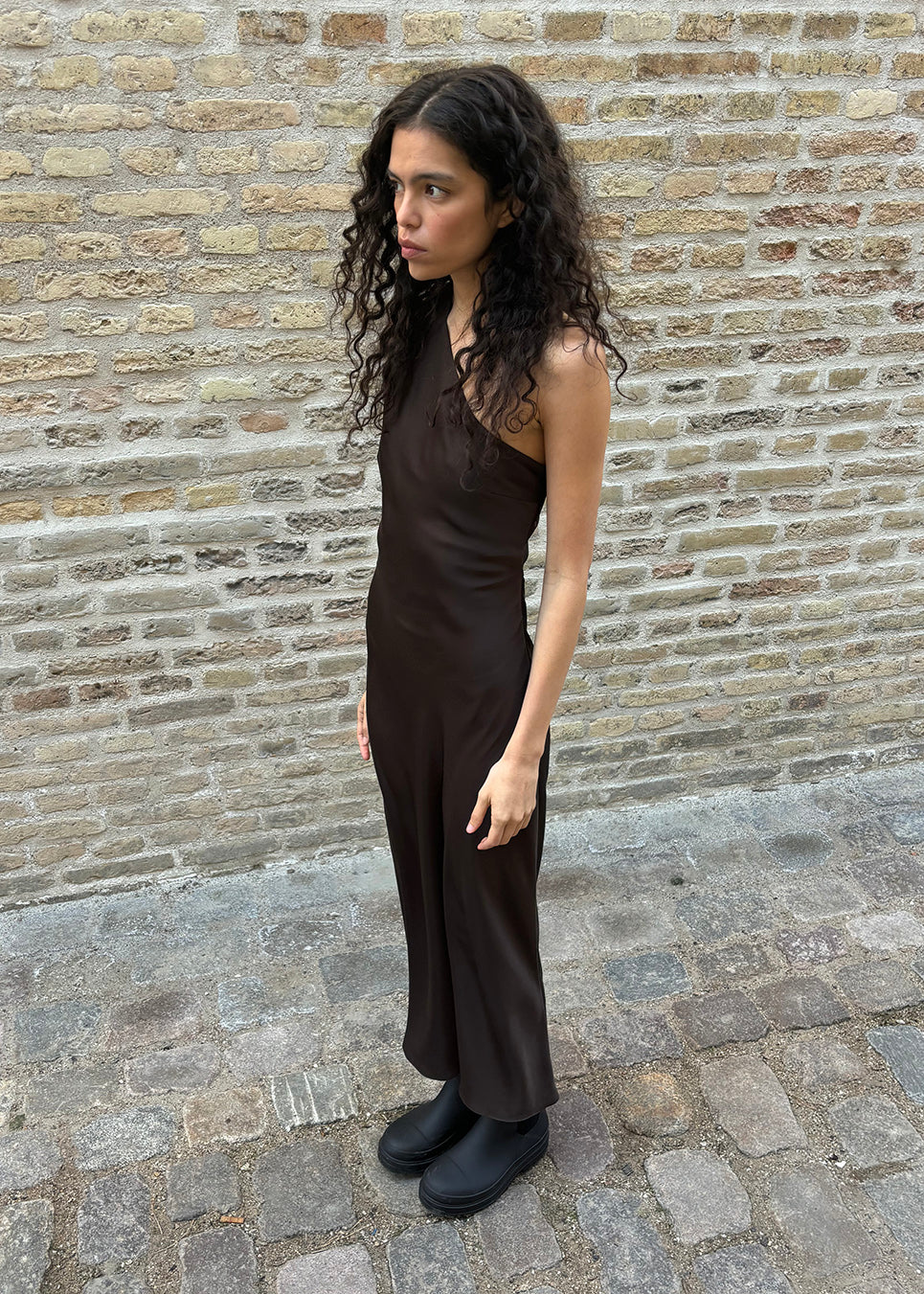 Dark brown maxi one-shoulder dress in satin. NarcissaMD dress has an open back with beautiful details and an invisible zipper on the side.