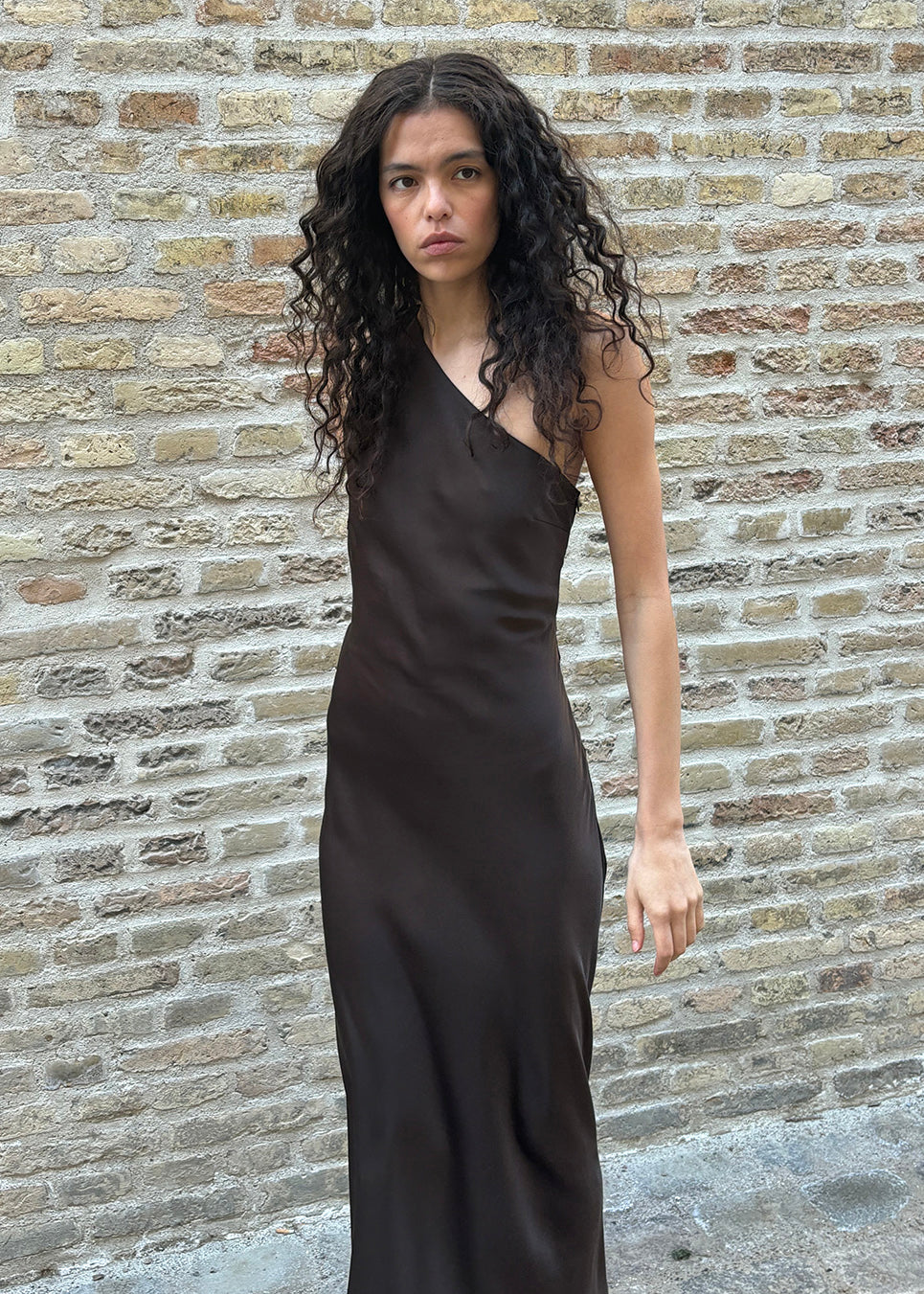 Dark brown maxi one-shoulder dress in satin. NarcissaMD dress has an open back with beautiful details and an invisible zipper on the side.