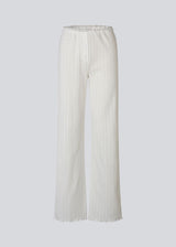 White pointelle pants. Josefinemd pants are feminine pointelle cotton trousers with lace trim and a subtle openwork pattern. Soft, comfortable, and ideal for relaxing at home. Josefine Vogt (165 cm) and the model (177 cm) are both wearing size Small.