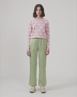 ClarkeMD print pants have straight, wide legs, and a medium waist with covered elasticated. The pants are made from recycled polyester with a smiley print.