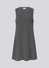 Short pinstriped dress without sleeves and with a deep v-neckline in front. AbrahamMD dress has an A-lined silhouette with skirt that cuts at the knees.