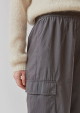 Pants in grey in recycled nylon. AmayaMD pants have a high waist and straight legs with adjustable drawstring at hem. Covered elasticated waist and two large pockets on the legs.