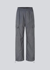 Pants in grey in recycled nylon. AmayaMD pants have a high waist and straight legs with adjustable drawstring at hem. Covered elasticated waist and two large pockets on the legs.