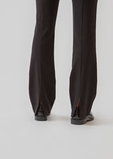 Pants in a slim silhouette with hidden closure at one side. AnkerMD slit pants have decorative paspel back pockets, sewn-in creases, and slits at hems.  Buy matching blazer: AnkerMD blazer, in the same color to complete the look.