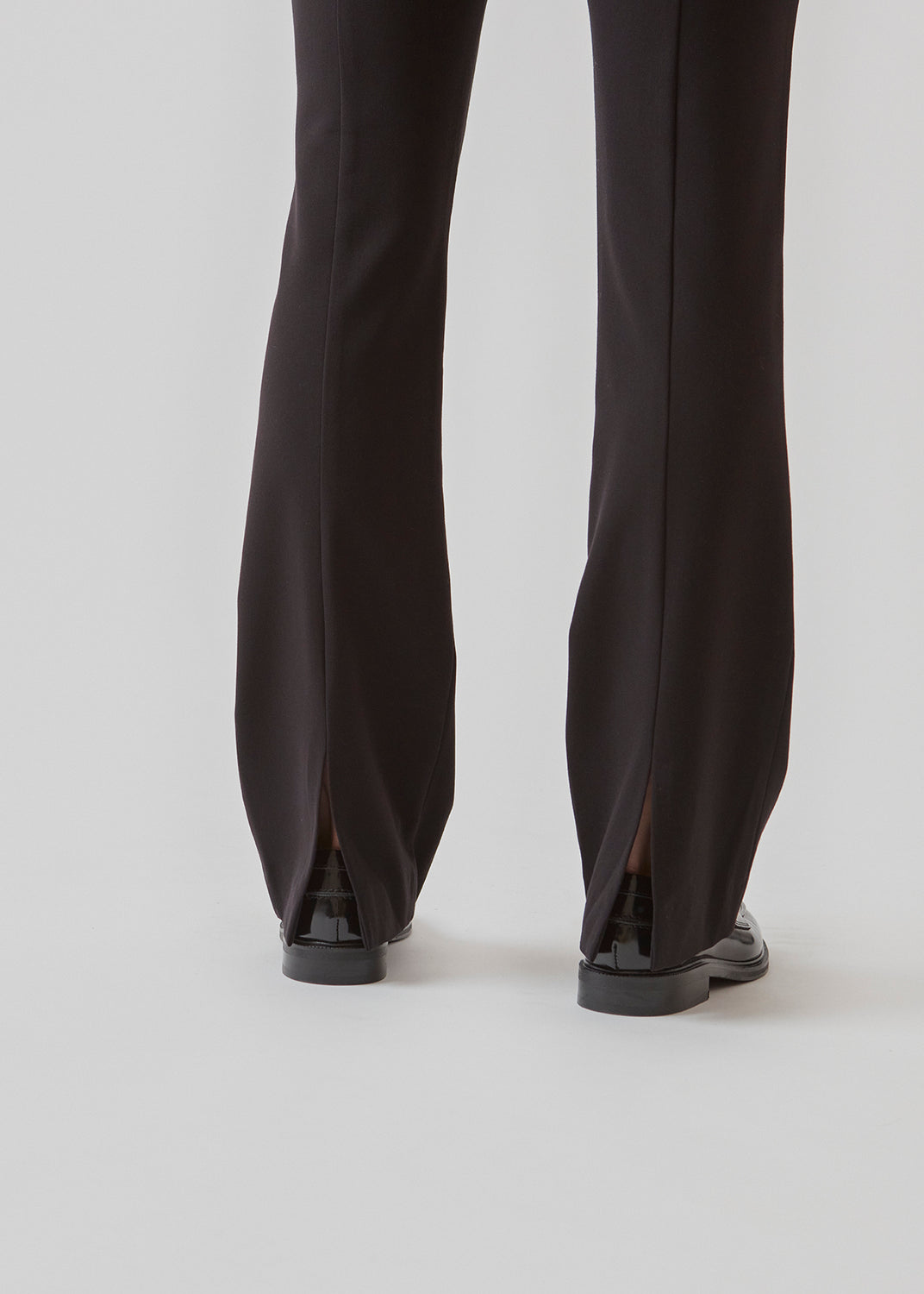Pants in a slim silhouette with hidden closure at one side. AnkerMD slit pants have decorative paspel back pockets, sewn-in creases, and slits at hems.  Buy matching blazer: AnkerMD blazer, in the same color to complete the look.
