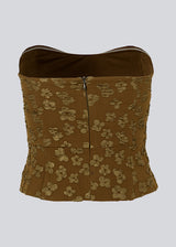 Crop top without sleeves with a heart-shaped neckline and a slight peplum effect. AtiraMD crop top has a structured floral pattern.
