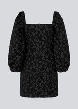Short dress in black with all-over floral structure. AtiraMD dress has long balloon sleeves and a more fitted body. The neckline is square in front and back.