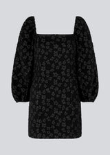 Short dress in black with all-over floral structure. AtiraMD dress has long balloon sleeves and a more fitted body. The neckline is square in front and back.