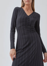 Tight dress in the color: Love Love Blue stretchable quality with print and A shape.BartoMD dress has long sleeves and V-neckline with wrinkle detail at the waist.
