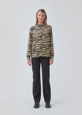 Shirt made from recycled materials. BeckyMD print shirt offers a relaxed fit with wide sleeves with cuff, shirt collar, and button closure in front.