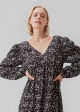 Long dress with elasticated puff sleeves, v-neckline in both front and back, and an elastic detail at the waist. CelineMD print dress is made from an EcoVero viscose with floral print.