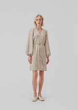 Short dress with print and long puff sleeves. ChrissyMD print dress is made with a v-neckline, closed by buttons in front, and tiebelt at the waist.