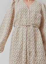 Short dress with print and long puff sleeves. ChrissyMD print dress is made with a v-neckline, closed by buttons in front, and tiebelt at the waist.