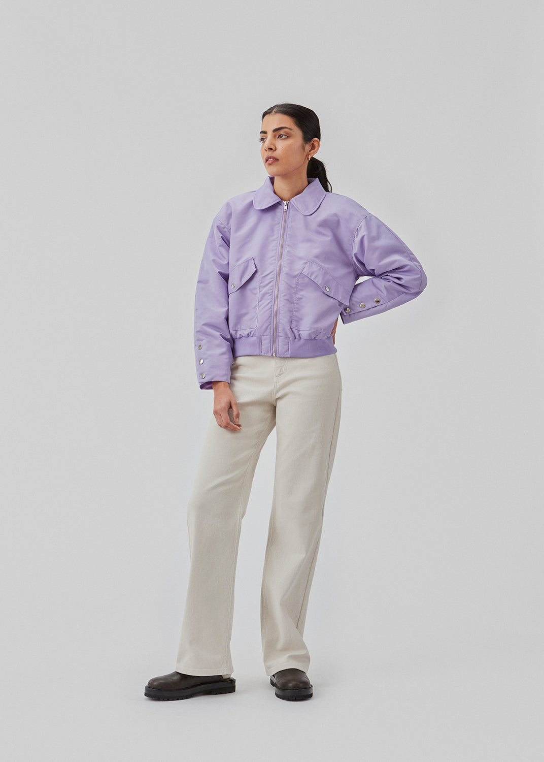 Short, padded bomber jacket in purple. ColtonMD jacket is designed with a collar, zipper in front, and pockets with push buttons. Ribbing at the hem.