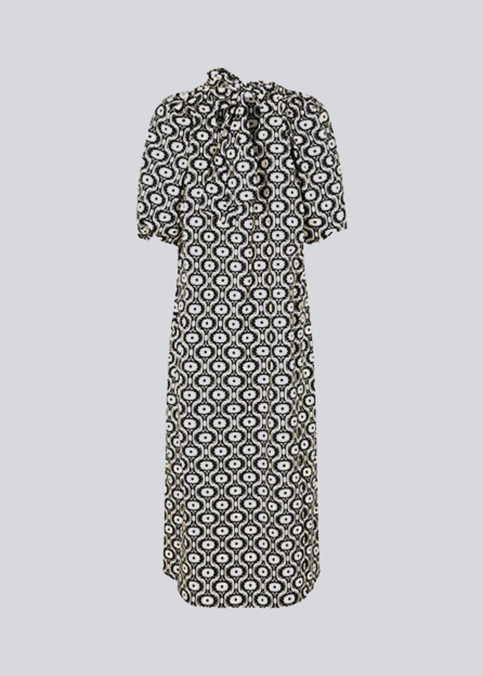 Long dress with a wide skirt and voluminous puff sleeves. CoraMD print dress has a round neck with a cut out and bow in the back. Made from organic cotton.  The model is 174 cm and wears a size S/36.