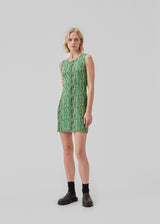 Tailored dress without sleeves cutting mid-thigh. CorbyMD dress is cut from a soft and stretchy printed quality. Hidden zipper in back.