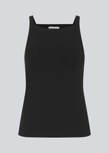 Tight fit basic black top with a high and straight neckline. DaeMD top is made from a rib-knitted organic cotton. The model is 177 cm and wears a size S/36.