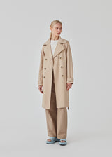 Beautiful jacket with a classic look and wide revers, belted waist and button closure. Hiro jacket is one of our most popular styles and the perfect transition jacket. This jacket has a spacious fit. We recommend sizing down. The model is 174 cm and wears a size S/36