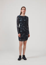Short dress with draped details and multiple layers. CliffordMD print dress has a round neck and long sleeves in mesh.  The model is 177 cm and wears a size S/36.