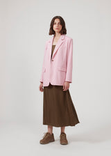 Oversized blazer in dusty sorbet with a drapey fit. AnkerMD blazer has collar and notch lapels with a single button closure. Flap welt front pockets. Slits on cuffs and single back vent. Lined.  The model is 177 cm and wears a size S/36.