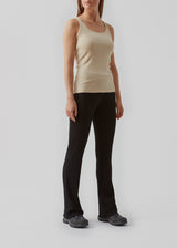 Olla top is a simple tanktop in a soft ribmaterial. The top has a tight and figure-hugging silhouette which has a soft feel under a knitted sweater or shirt.