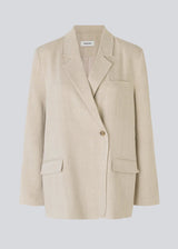 Blazer in a voluminous fit with an asymmetrical look. Park blazer in Cream Milk is made from an airy linen quality, which is easy to style with the matching pants or over a dress on a summer evening.